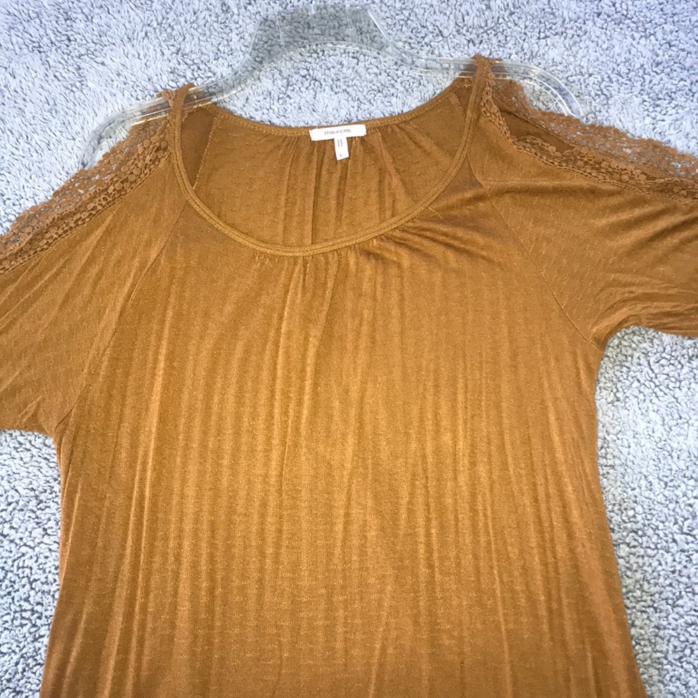 Mustard top with exposed shoulders/arm.